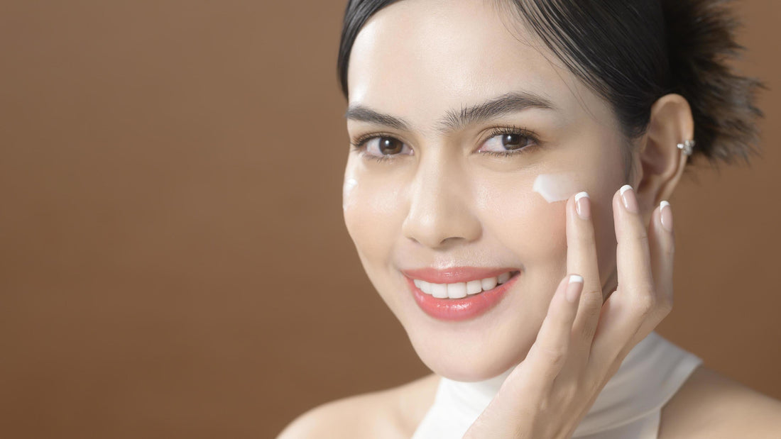 woman putting cream on her face