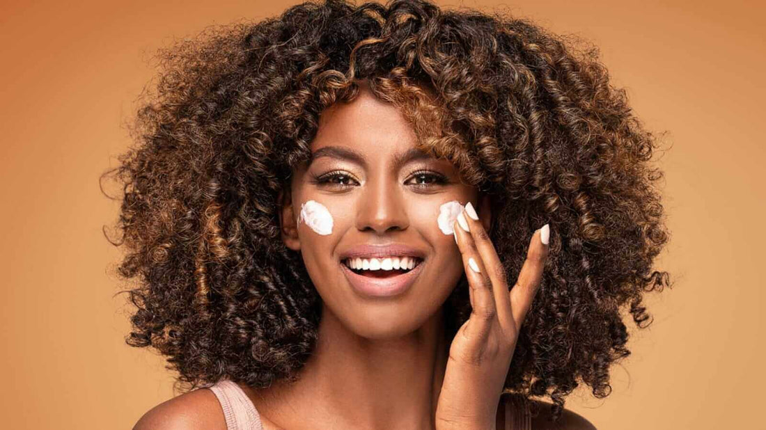 A woman putting cream on her face